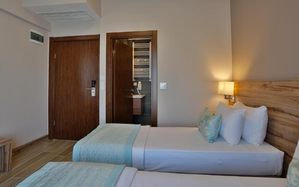 Postel nebo postele na pokoji v ubytování Kule Hotel