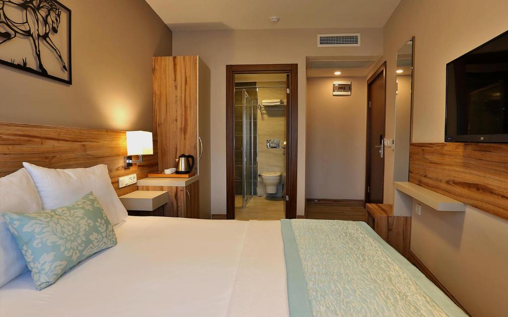 Postel nebo postele na pokoji v ubytování Kule Hotel