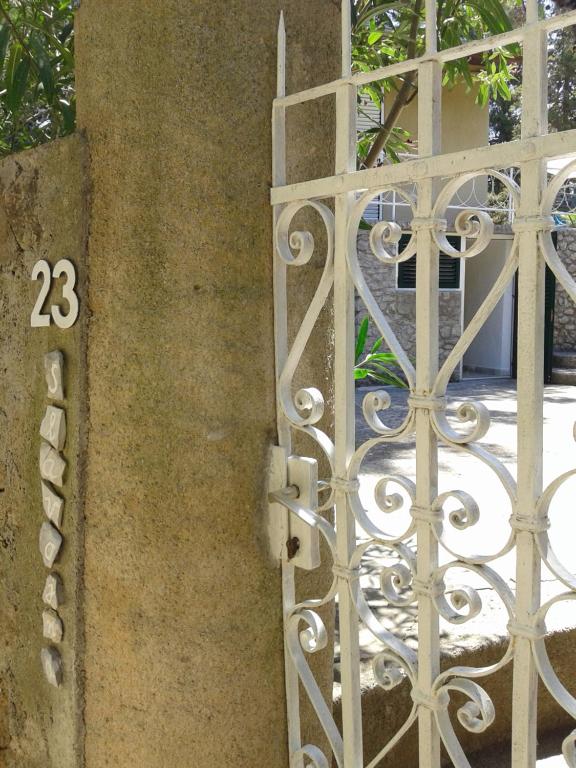 an iron gate with the number on it at Holiday Home Paradizo in Veli Lošinj