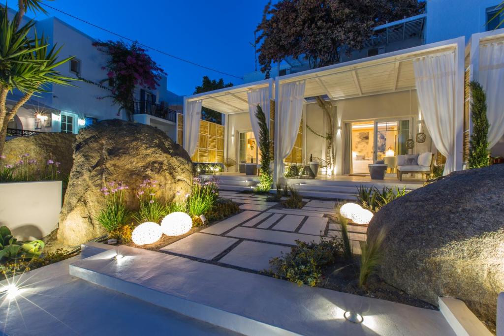 an exterior view of a house with rocks and plants at Sea Nymphs Suites in Agia Anna Naxos