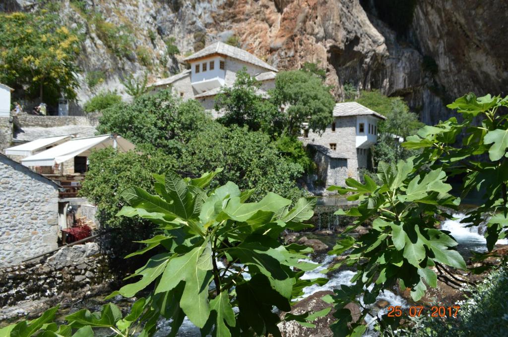 a building on the side of a mountain at Apartment Enny in Blagaj