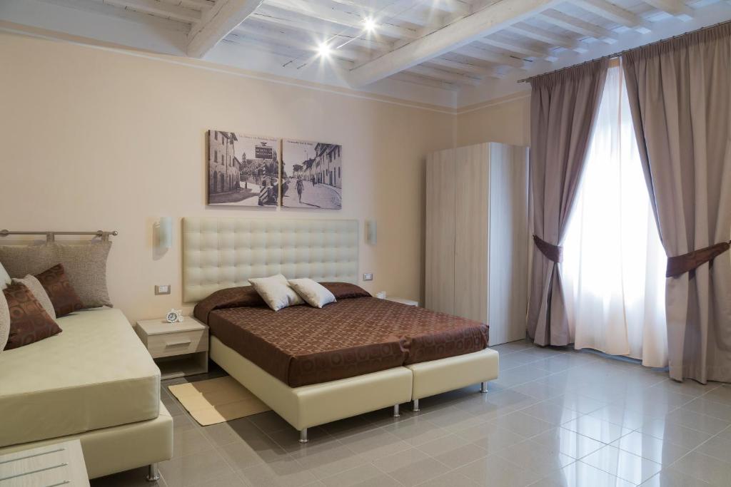 a bedroom with a bed and a couch in it at VIA NALDINI n 61 in Tavarnelle in Val di Pesa