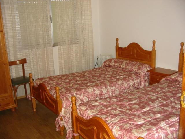 a bedroom with two beds and a window at A Salanova in Salcedo