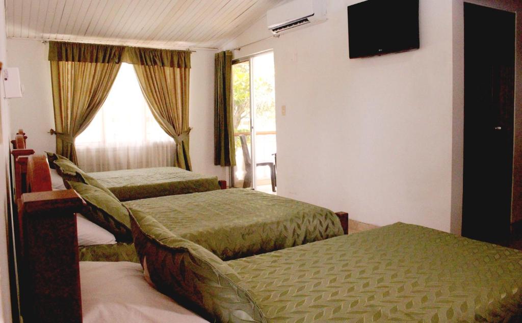 Postel nebo postele na pokoji v ubytování Alborada Hotel Melgar