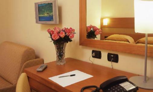 Postel nebo postele na pokoji v ubytování Hotel Moscatello