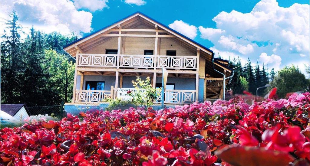 a house in the middle of a field of flowers at Apartamenty Karkonoskie in Karpacz