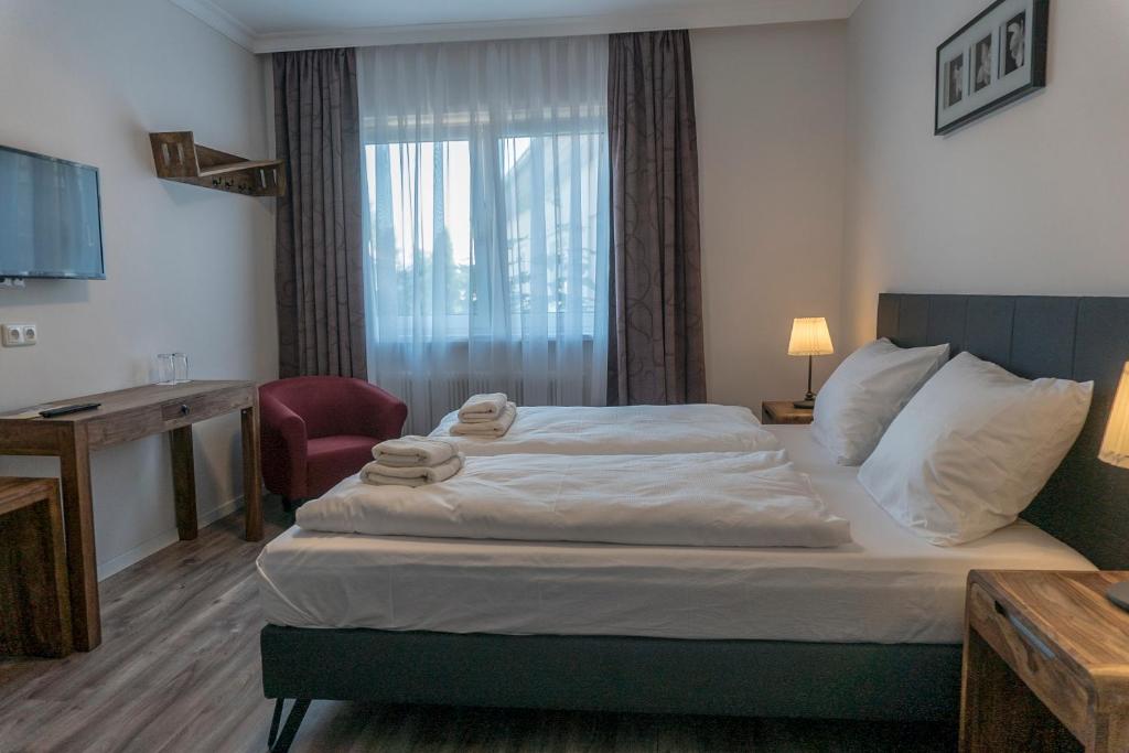 Posteľ alebo postele v izbe v ubytovaní Pension zum Meridianstein