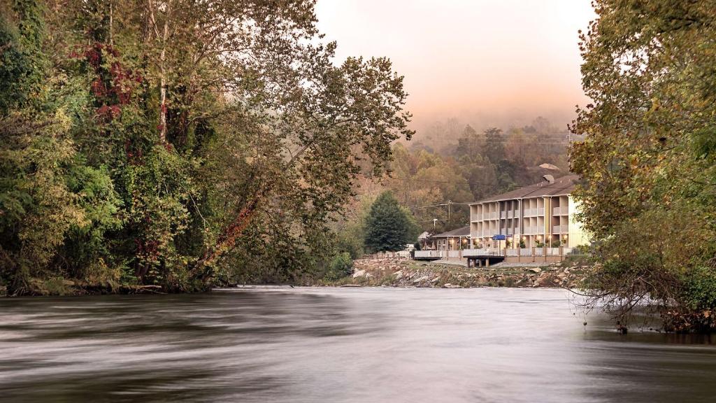 Blick auf einen Fluss mit einem Gebäude im Hintergrund in der Unterkunft Best Western Plus River Escape Sylva / Dillsboro in Dillsboro