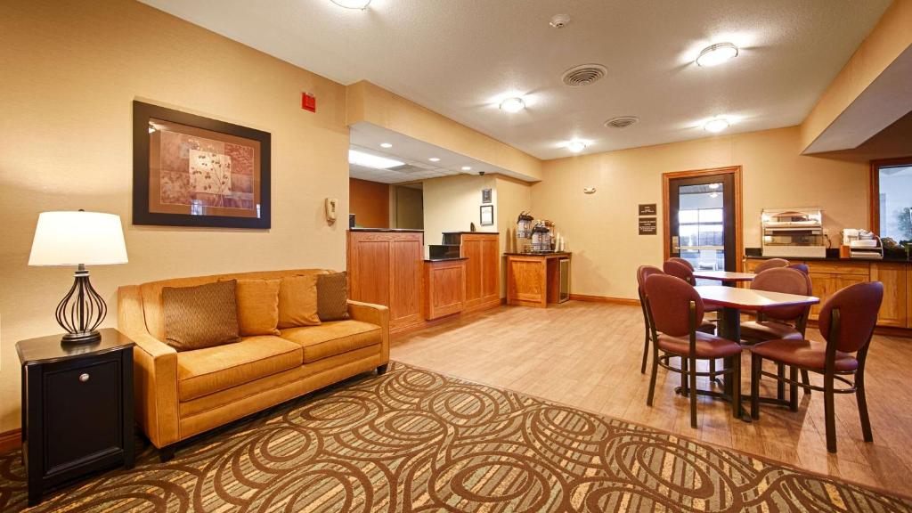 a living room with a couch and a table at Best Western Pontiac Inn in Pontiac