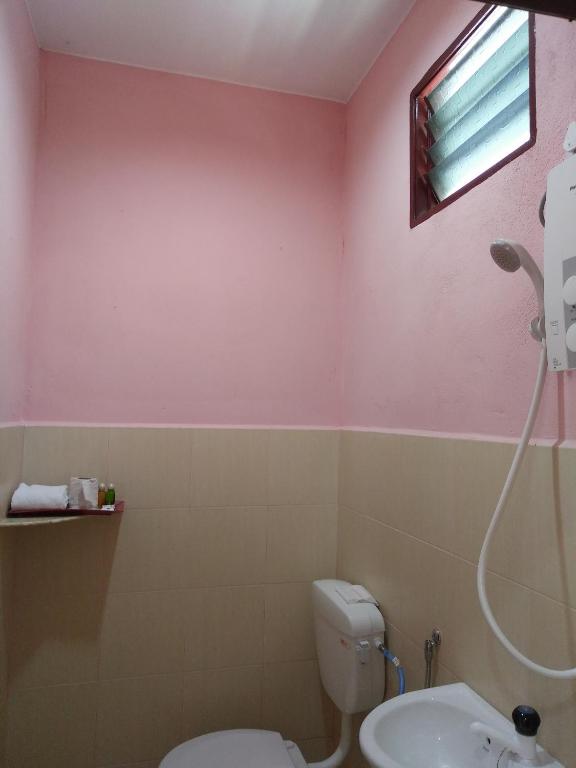a bathroom with a toilet and a sink at Sri Melor Inn in Pantai Cenang