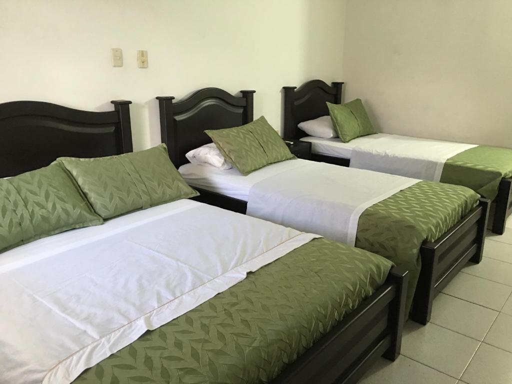 Postel nebo postele na pokoji v ubytování Alborada Hotel Melgar