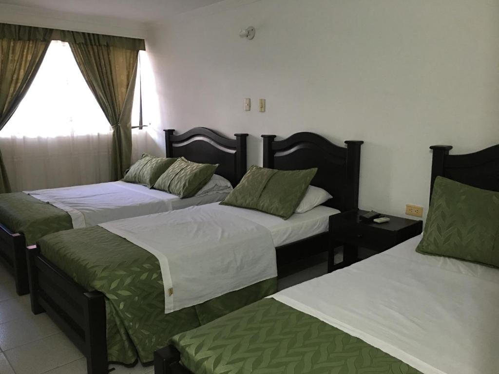 Postel nebo postele na pokoji v ubytování Alborada Hotel Melgar