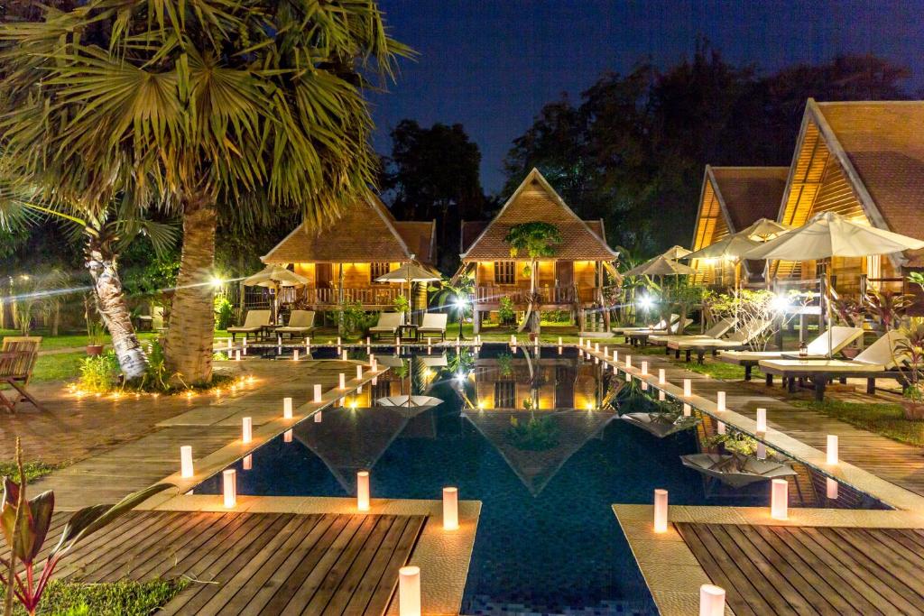 a resort with a swimming pool at night at Angkor Heart Bungalow in Siem Reap