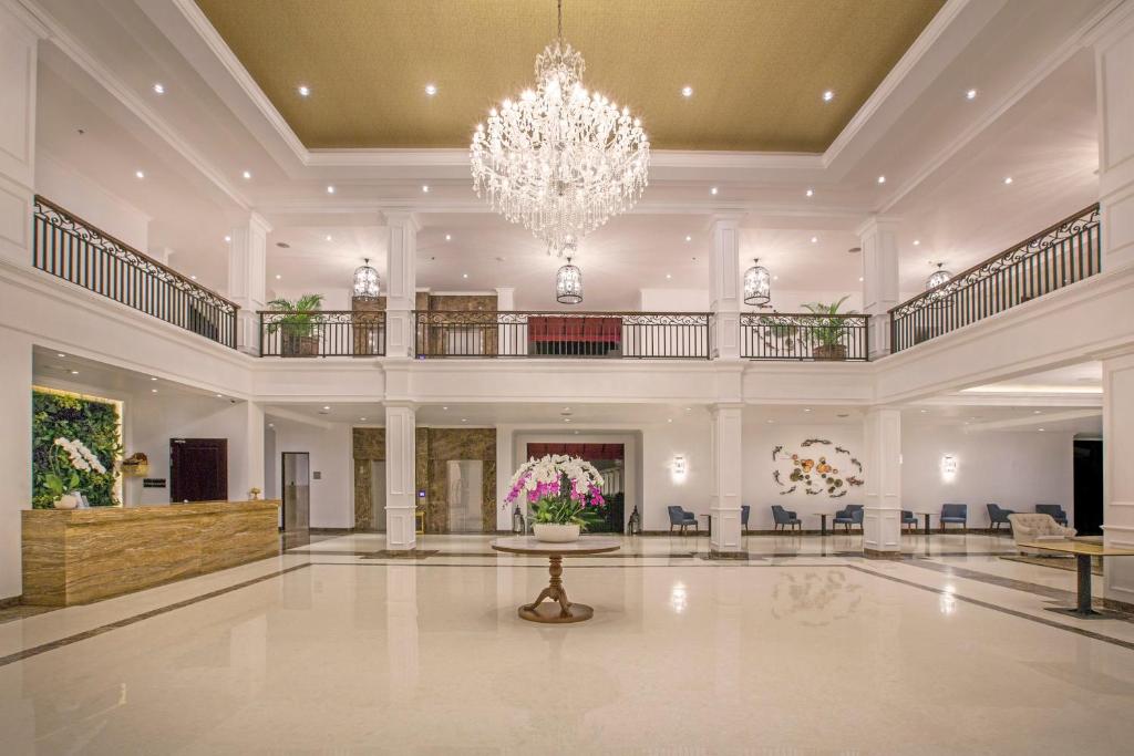 a large lobby with a chandelier and a table at Grand Palace Hotel Sanur - Bali in Sanur