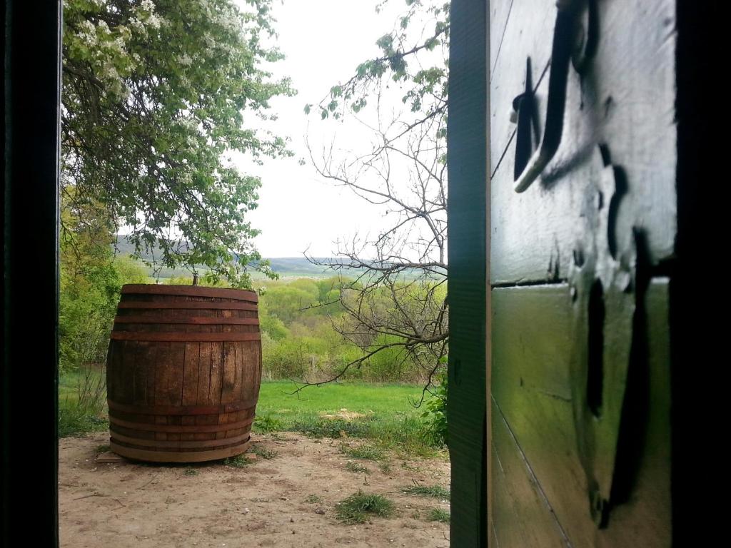 a wooden barrel sitting next to a door at Cottage by the woods in Balatonhenye