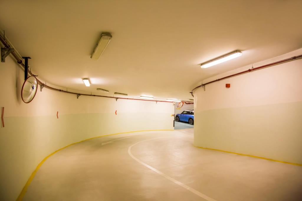 an empty garage with a car parked in it at Grand Mercure Majlis Residences in Abu Dhabi
