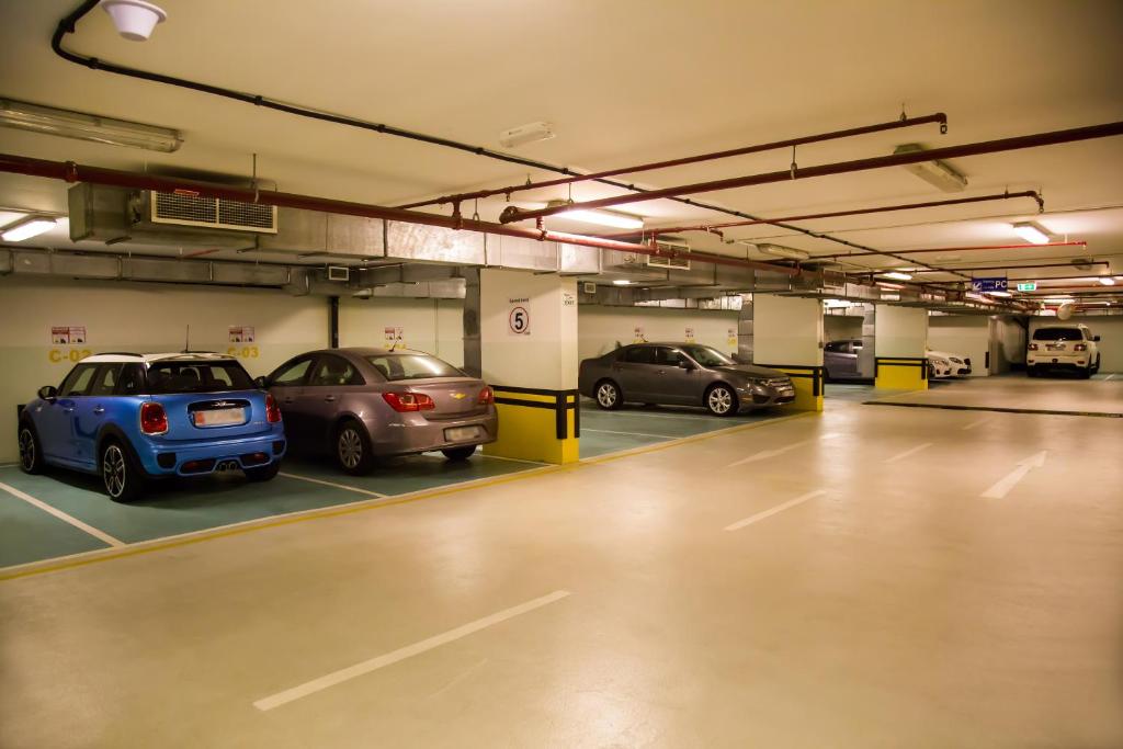 a parking garage with several cars parked in it at Grand Mercure Majlis Residences in Abu Dhabi