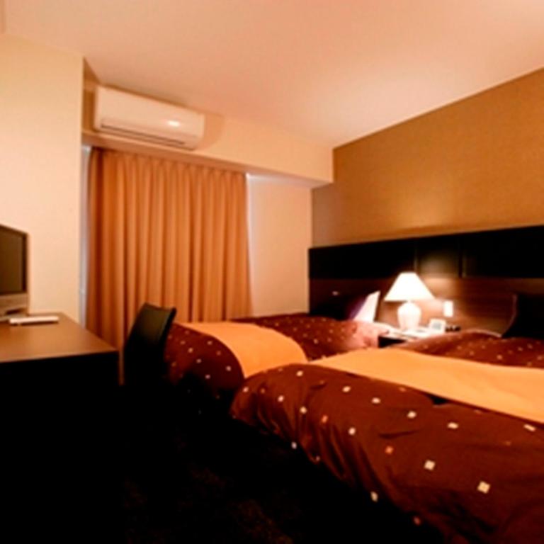 Postel nebo postele na pokoji v ubytování Hotel 1-2-3 Takasaki