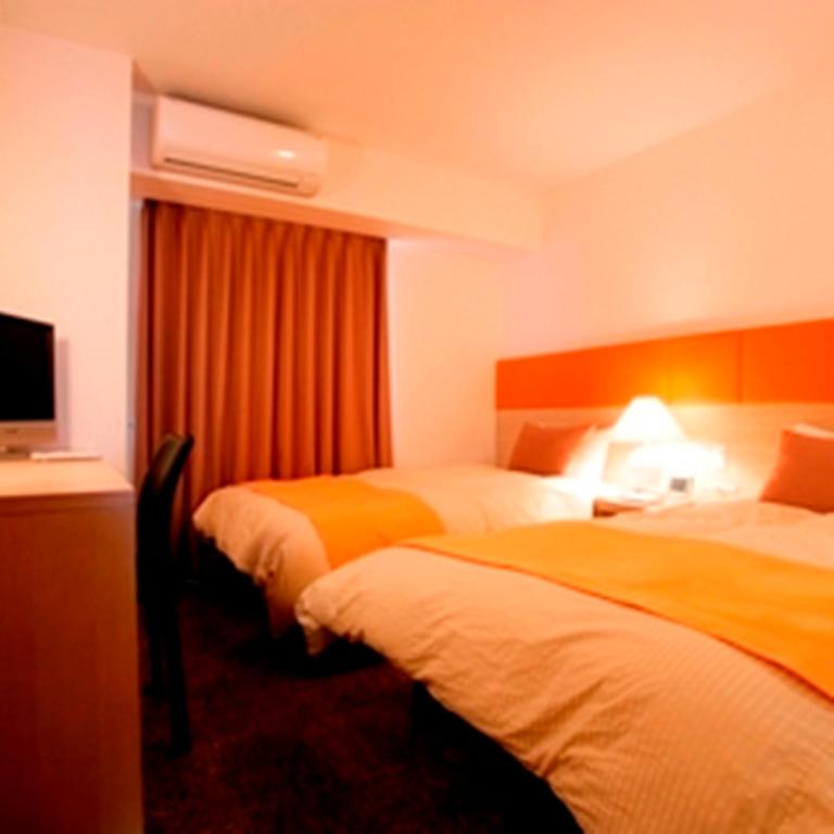 Postel nebo postele na pokoji v ubytování Hotel 1-2-3 Takasaki