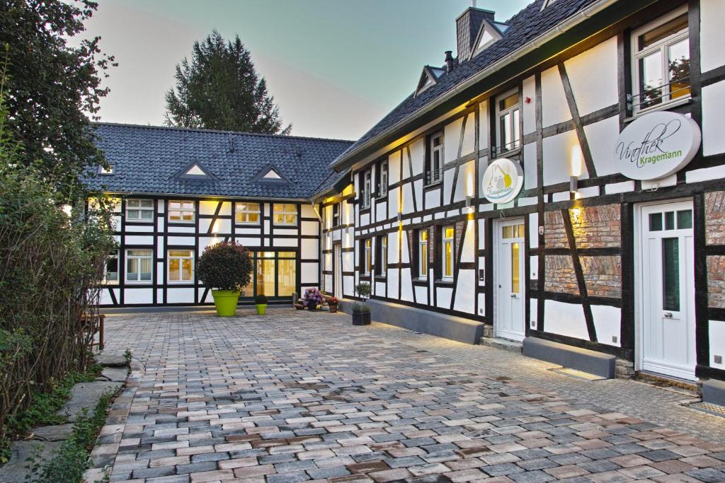 a cobblestone street in front of a building at Kragemann Hotel & Vinothek in Simmerath