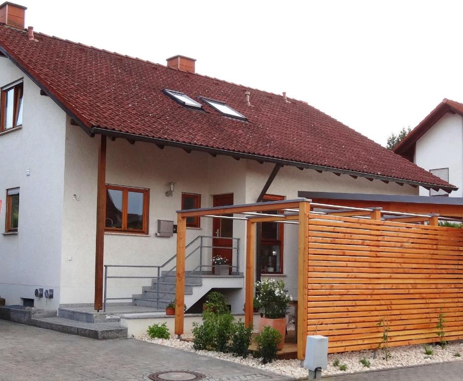 una casa con una valla de madera delante de ella en Ferienwohnung im sonnigen Kaiserstuhl, en Endingen am Kaiserstuhl