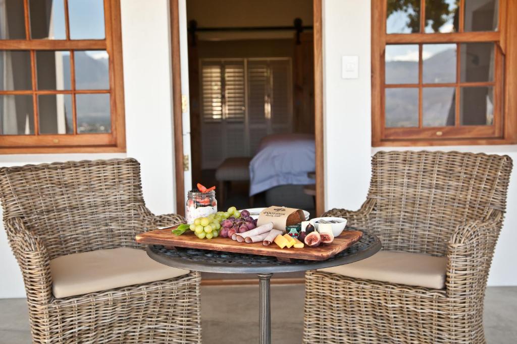 a tray of food sitting on a table with two chairs at d'Olyfboom Guest House B & B in Paarl