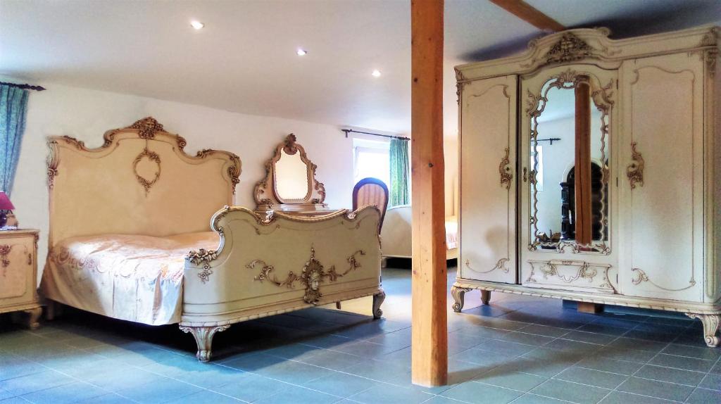 a bedroom with a bed and a large mirror at Ubytovani Sarka in Čistá