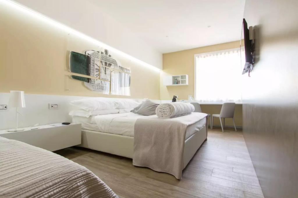 Postel nebo postele na pokoji v ubytování Ginevra Rooms