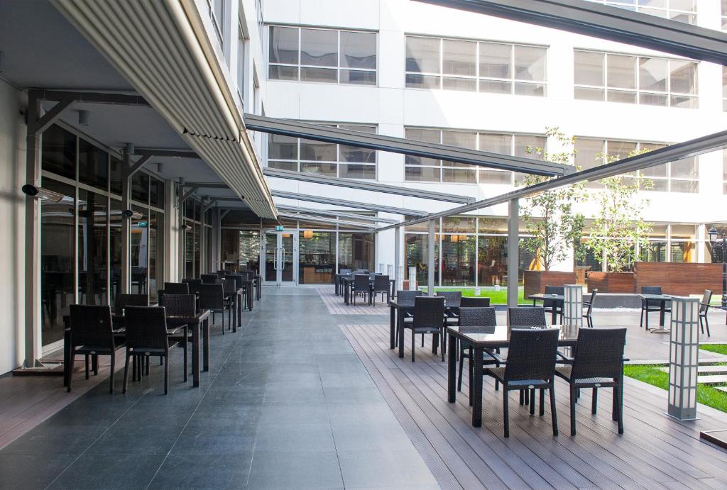 a row of tables and chairs in a building at ISG Sabiha Gökçen Airport Hotel in Istanbul