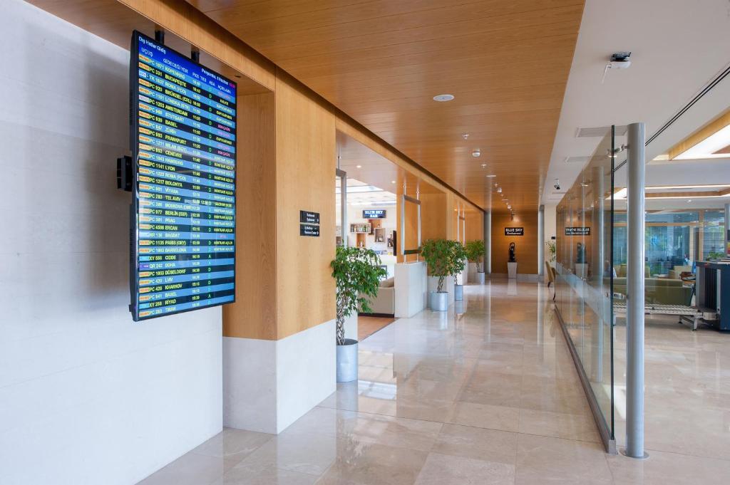 a large monitor on the wall of a hospital lobby at ISG Sabiha Gökçen Airport Hotel in Istanbul