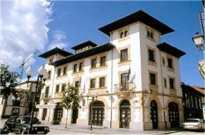 a large white building with a black roof at Casa España in Villaviciosa