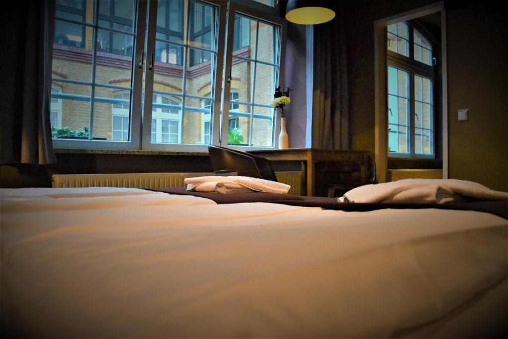 Postel nebo postele na pokoji v ubytování Singer109 Hostel, Hotel & Apartment