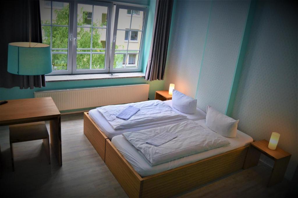 Postel nebo postele na pokoji v ubytování Singer109 Hostel, Hotel & Apartment