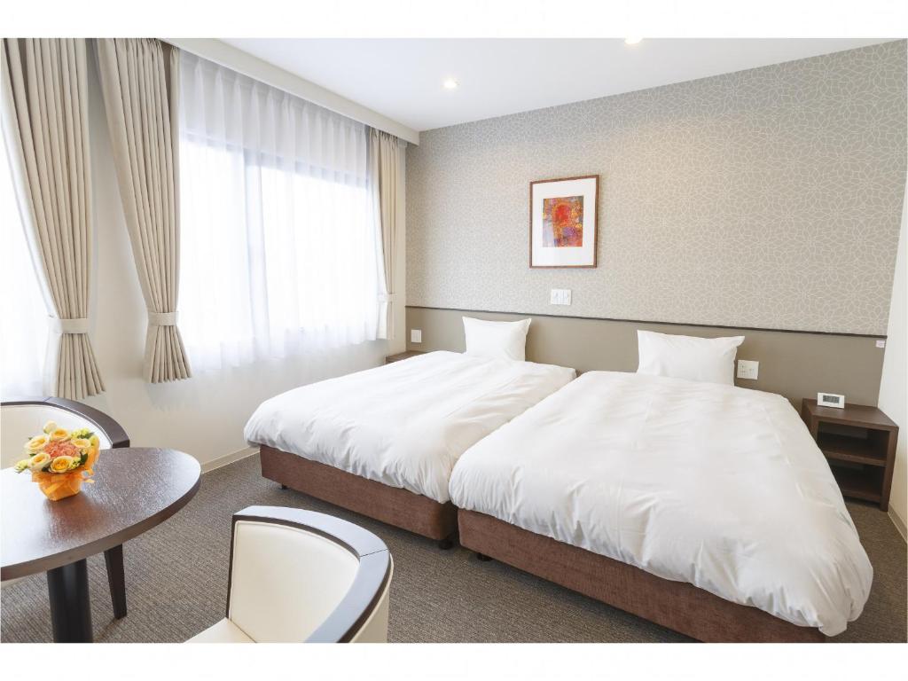 Postel nebo postele na pokoji v ubytování Hotel Amabile Maizuru