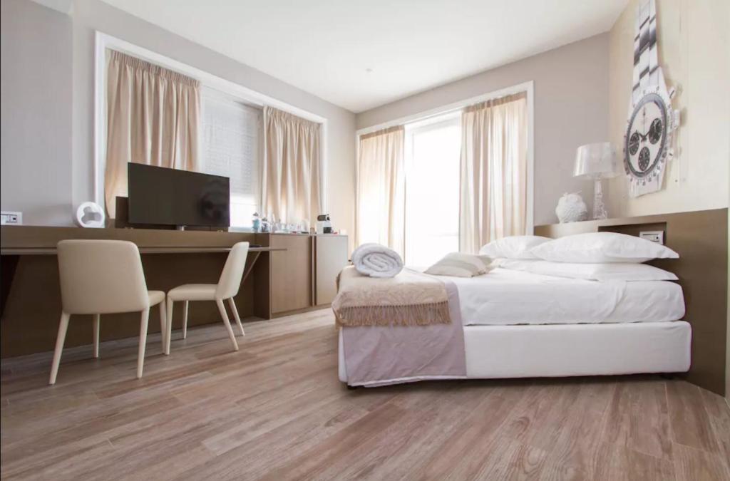 Postel nebo postele na pokoji v ubytování Ginevra Rooms