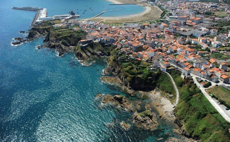 an aerial view of a town next to the ocean at Hostal Restaurante La Cepa in Cariño