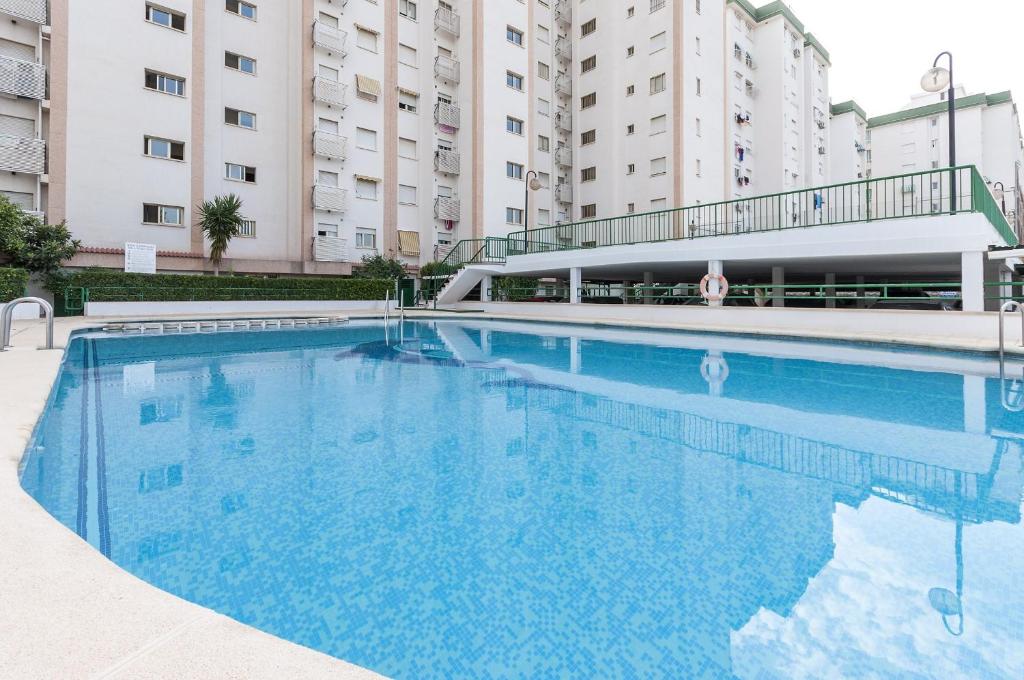 a large swimming pool in front of some buildings at Nube in Gandía