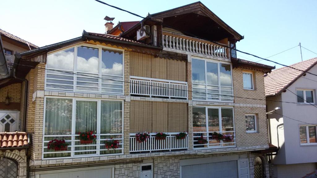 a house with large windows on the side of it at Holiday Home Old Town in Sarajevo