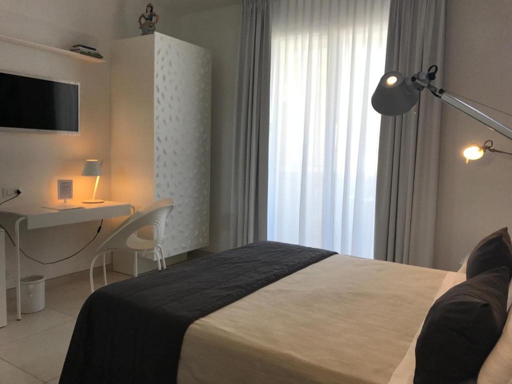 Postel nebo postele na pokoji v ubytování QuiHotel