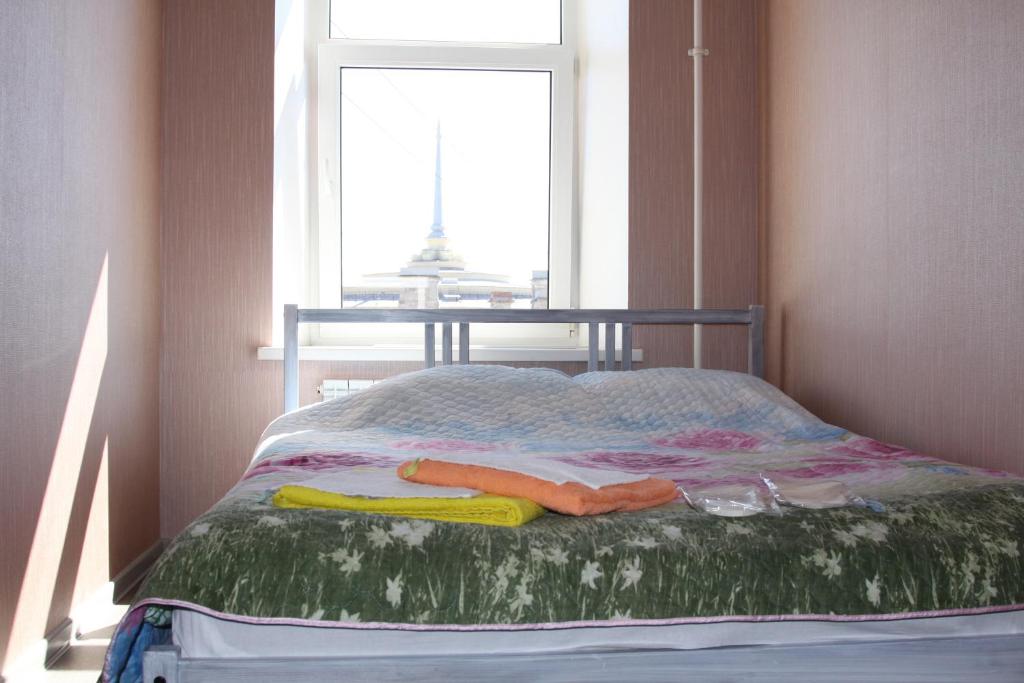 a bed in a room with a window at Hotel Pastel on Vosstaniya in Saint Petersburg