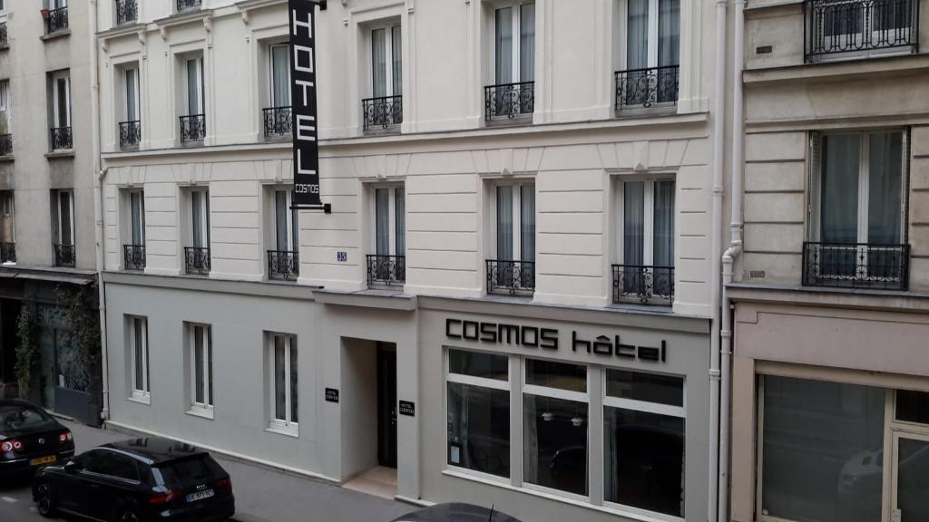 a building with a sign for a boutique hotel at Hotel Cosmos in Paris
