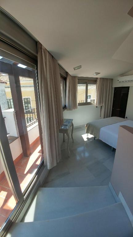 Postel nebo postele na pokoji v ubytování Apartamentos Torre de la Mezquita