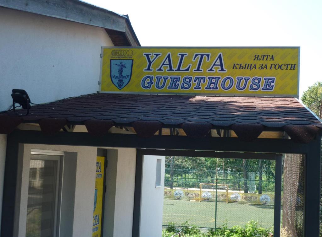 un cartel en un edificio con pista de tenis en YALTA guesthouse en Ruse