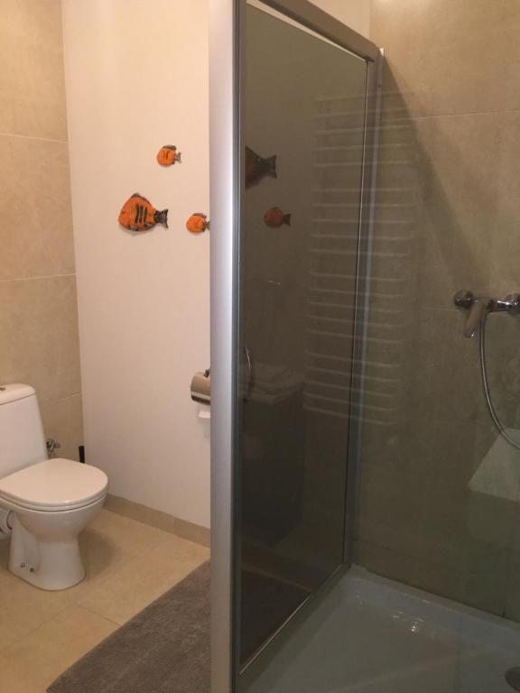 a bathroom with a shower with a toilet and fish hooks at Hotel i Restauracja Jan in Bełchatów