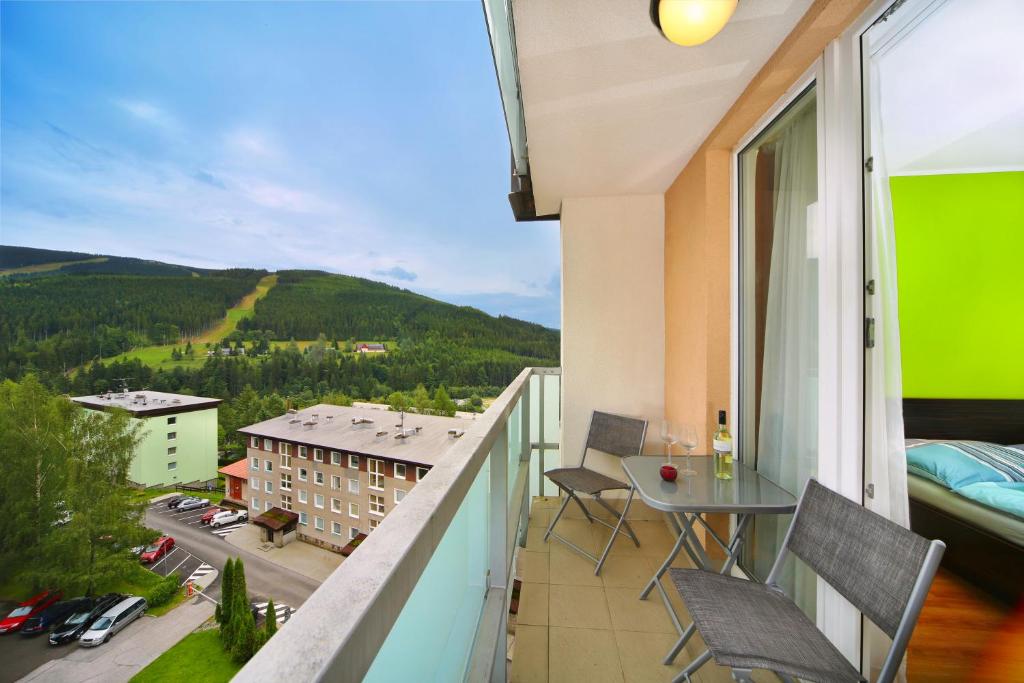 a balcony with a view of a city at Apartment 91/65 Špindlerův Mlýn in Špindlerův Mlýn