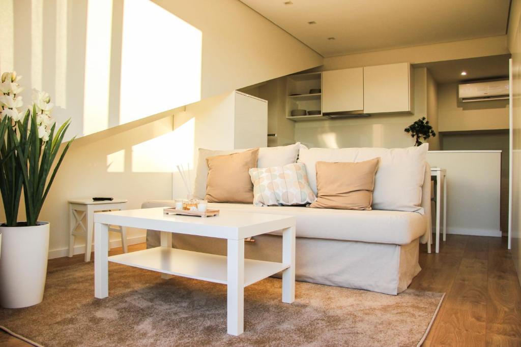 a living room with a couch and a table at Braga Center Apartments - Rua do Alcaide in Braga