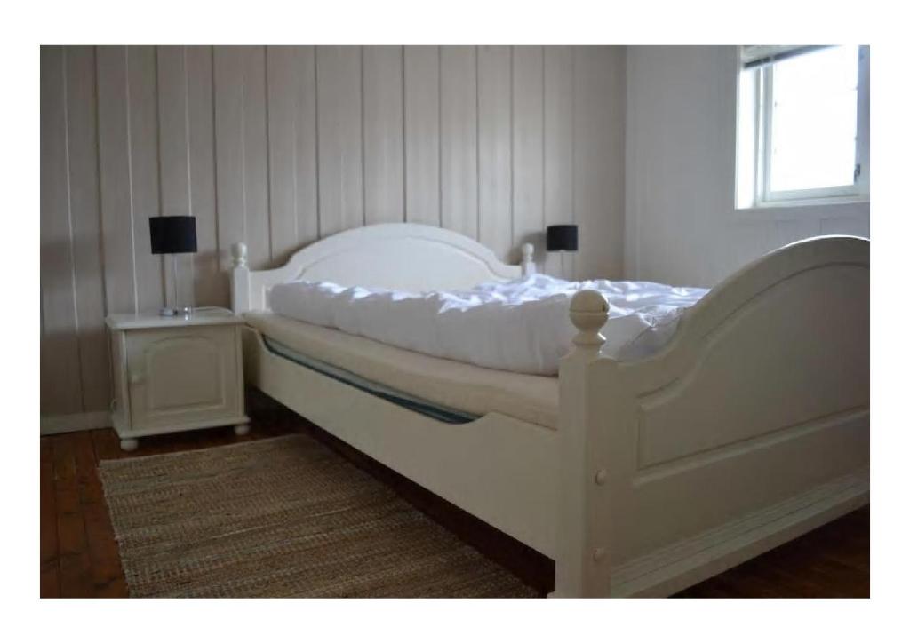 Säng eller sängar i ett rum på Kaikanten Kro og Rorbu