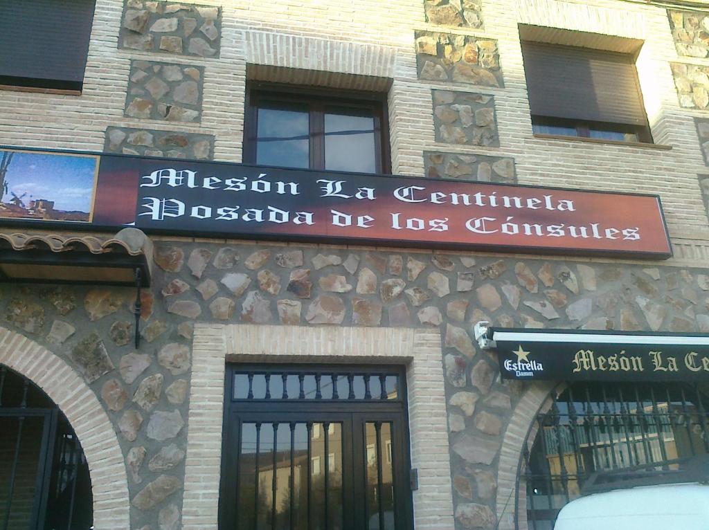 a building with a sign on the side of it at Posada de los Cónsules in Consuegra