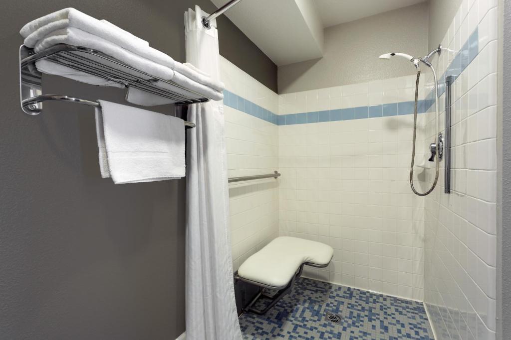 a bathroom with a shower and a toilet at Super 8 by Wyndham Fortuna in Fortuna