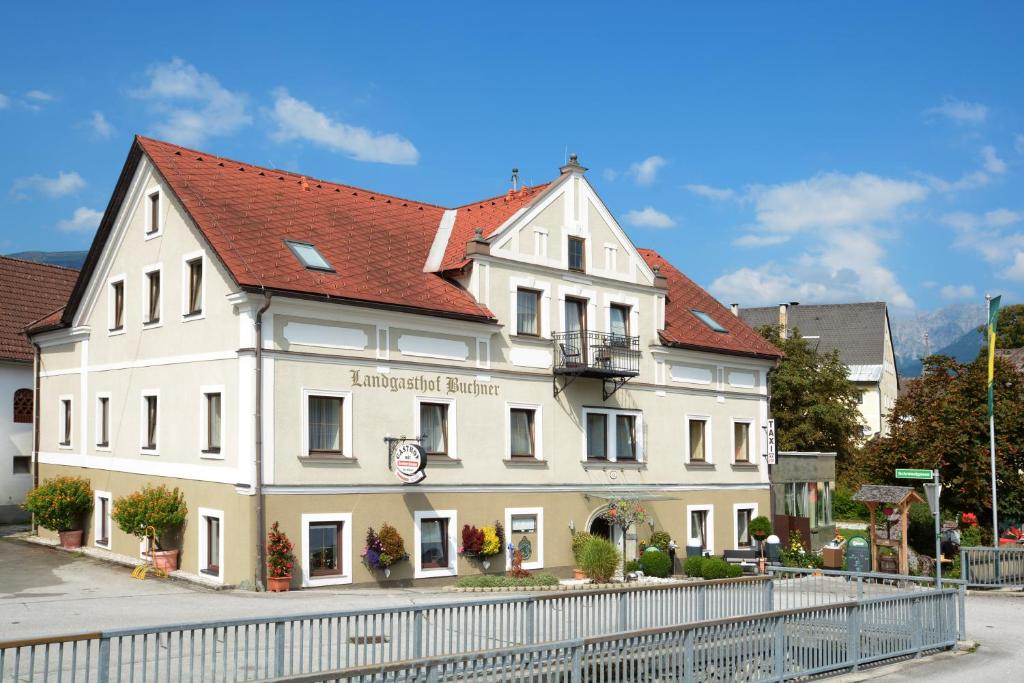 a white building with a red roof at Landgasthof Buchner in Admont